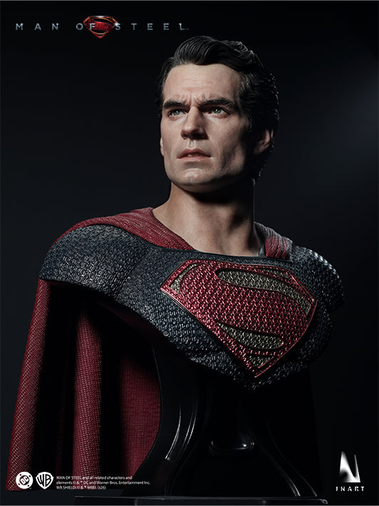 Side portrait of the INART Man of Steel Superman figure with red cape and textured chest emblem