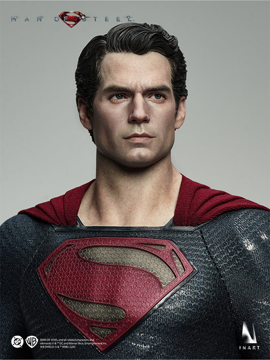 Close-up portrait of the INART Man of Steel Superman figure with articulated eyes and red cape