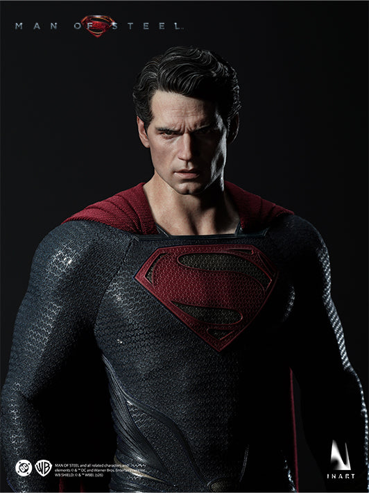 INART Man of Steel Superman figure looking downward in a dramatic pose with the red cape