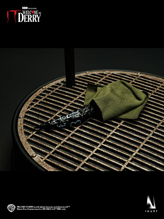 INART Pennywise meteorite dagger and wrapping cloth on sewer pipe display base