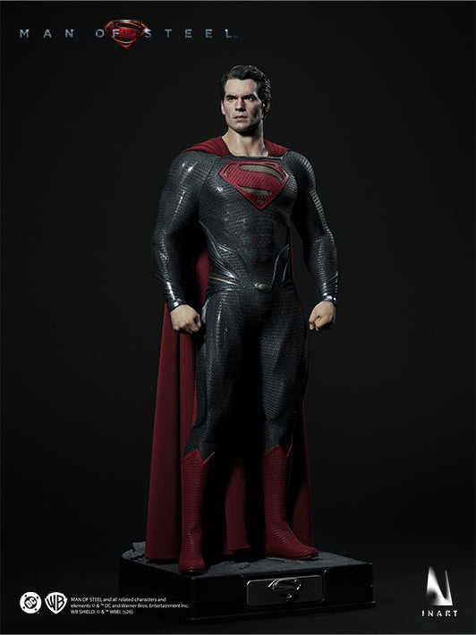 Three-quarter full-body view of the INART Superman figure with Kryptonian suit, cape and display base